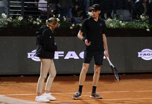 Jannik Sinner speaks with an official