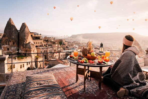 Woman looking at hot air balloons in Turkey
