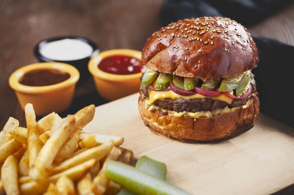 Delicious Cheeseburger with French Fries on Wood.