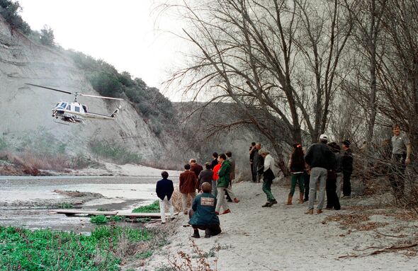 Court Officials watch a Los Angeles County Fire Department helicopter fly a similar route above the Santa Clara River