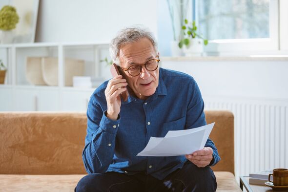 Worried senior man talking on phone