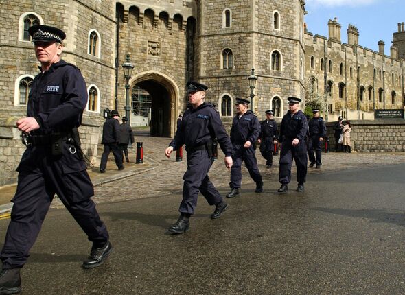 British policemen walk in front of the Windsor Castle
