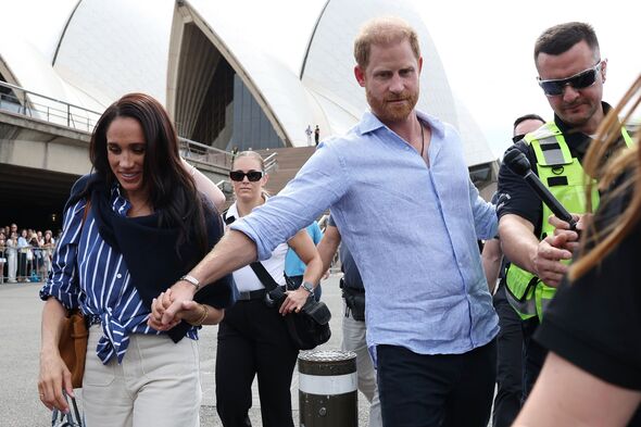 Meghan and Harry hold hands during visit in Aus