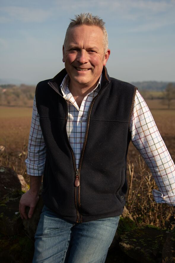 Jules Hudson sits on field fence