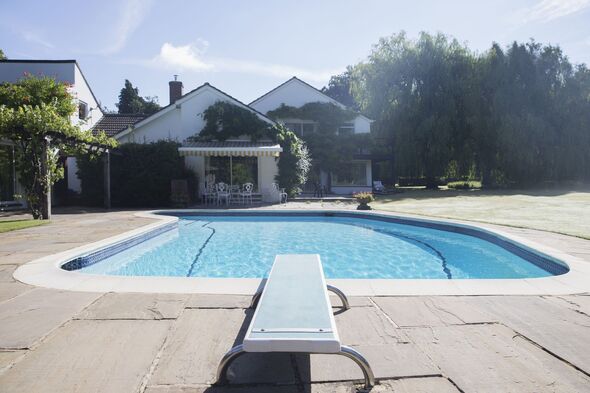 Diving board at the edge of swimming pool