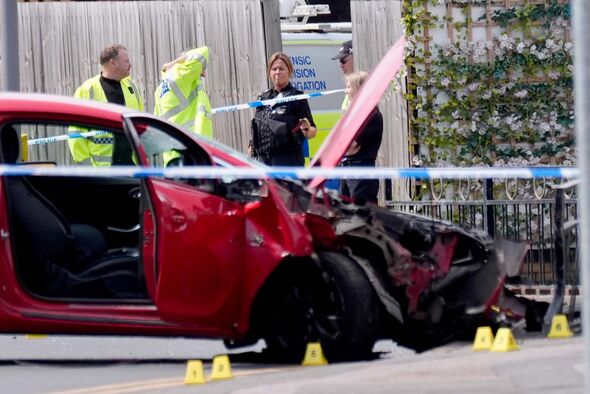 Police officers at the scene of the crashed car in Market Place, Arnold