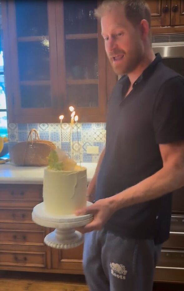 Prince Harry carrying a cake