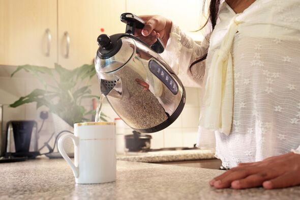 A person pouring water from a kettle