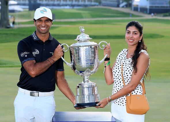 Aaron Rai of England, the 2026 PGA Champion, poses with the Wanamaker Trophy and his wife Gaurika Rai.