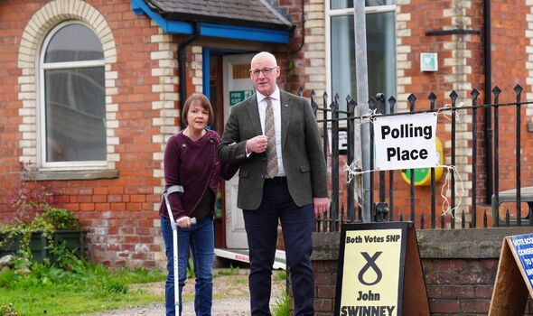 Scottish National Party (SNP) leader John Swinney and his wife Elizabeth arrive to cast their votes