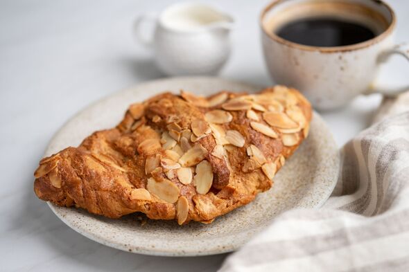 Almond croissant and cup of black coffee