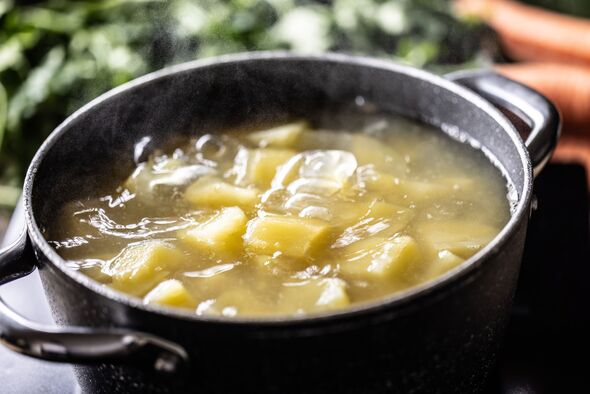 Preparing potatoes by boiling them in a pot. The chopped potatoes are boiled in salted water.