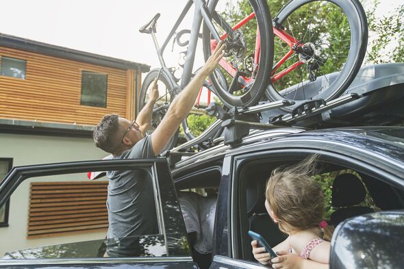 Man loading bikes onto car