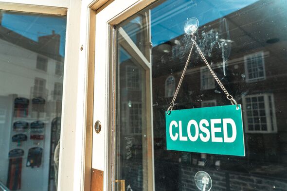 Business storefront door with a closed sign in Towcester