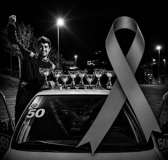 A black-and-white photograph depicts a solemn scene at night. An individual stands before a car, raising a hand, with a series o