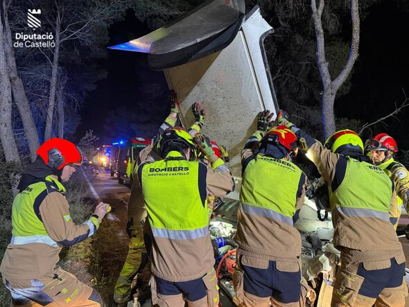 Emergency services personnel in high-visibility safety vests and helmets are engaged in a coordinated operation, possibly involv