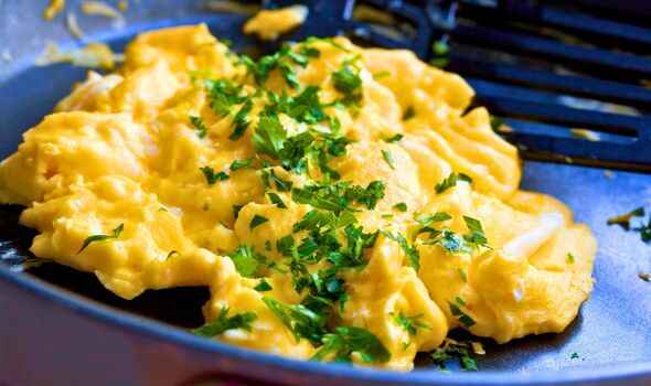 Picture of scrambled eggs cooking in a pan
