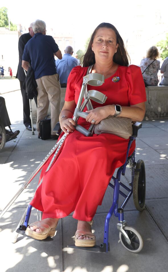 Lucy Hutley in wheelchair with crutches