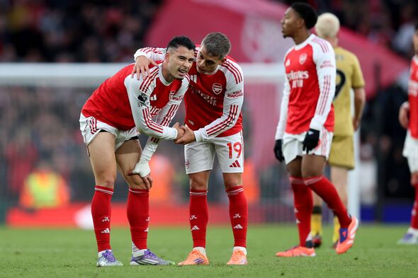 Leandro Trossard of Arsenal checks on injured teammate Gabriel Martinelli at the final whistle during the Premier League match b