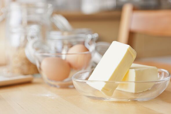 Butter and eggs on wooden table