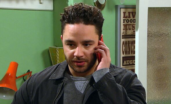 Adam Barton talks on the phone during an emmerdale scene