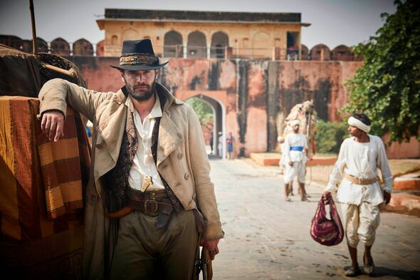 Tom Bateman wearing a hat in Beecham House