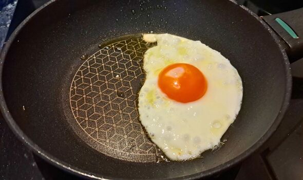 Picture of a fried egg cooking in a pan