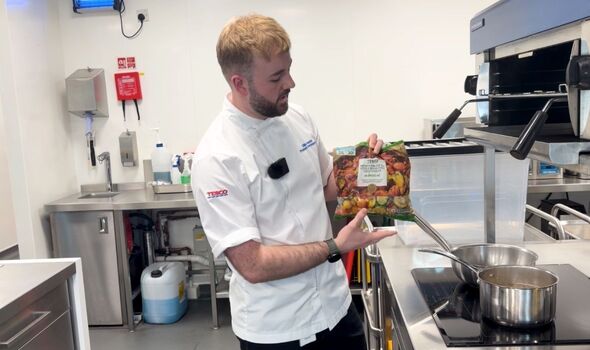 Tesco’s Development Chef Oliver Pedrick holding bag of frozen Tesco vegetables