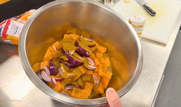 Butternut squash in bowl with onions and curry powder