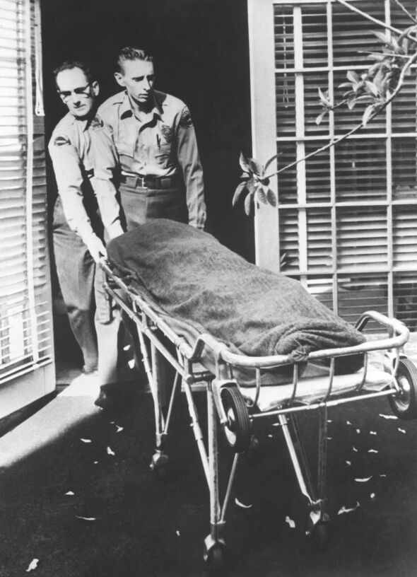 Body of Marilyn Monroe is wheeled out of her LA home