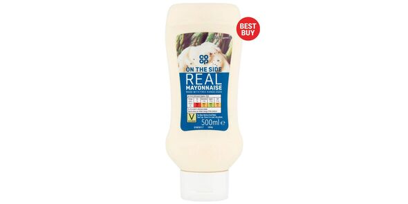 A bottle of Co-op On The Side Real Mayonnaise standing on its lid on a white background