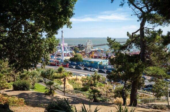 A view across Southend Cliff Gardens towards Adventure Island theme park and Southend Pier, Essex, UK.