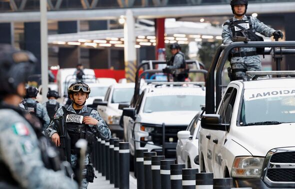 Mexican National Guard troops stand guard after the Iranian national soccer team departed