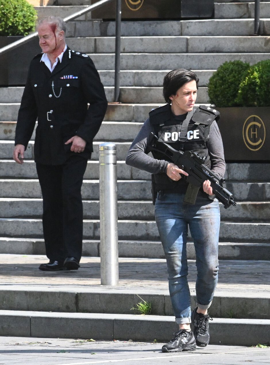 Vicky holding a gun filming scenes for the show