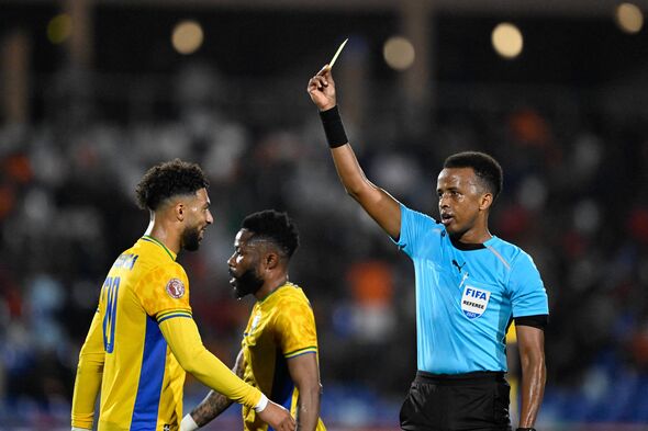 Omar Artan giving a player a yellow card