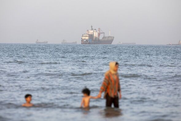 People swim in the Strait of Hormuz in Bandar Abbas