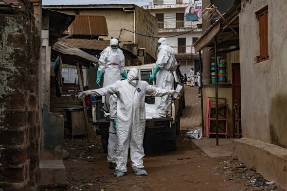 Uganda Red Cross worker sprayed with disinfectant