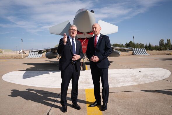 Sir Keir Starmer and Defence Secretary John Healey stand in front of a fighter jet during a visit to Turkey