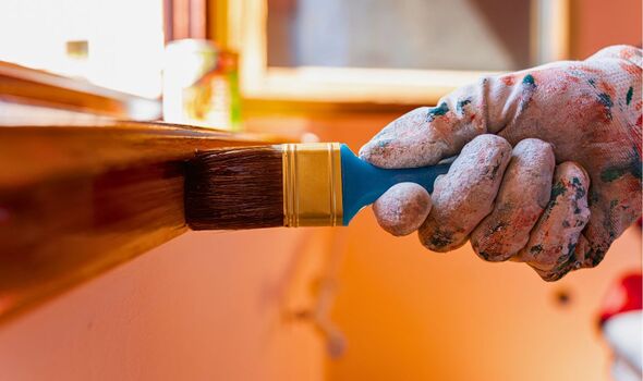 Picture of someone oiling a windowsill