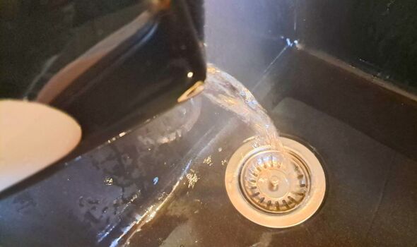 Picture of me pouring hot water down the drain