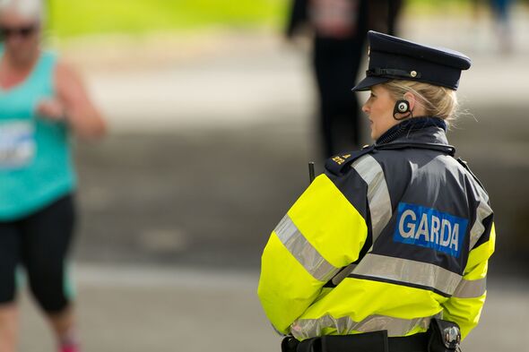 Female Garda Officer watching marathon runners