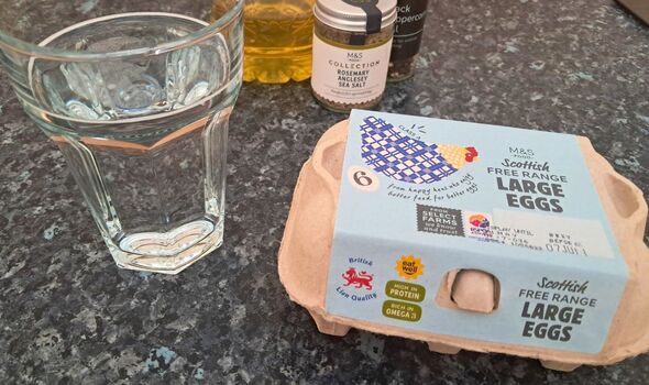 Picture of a carton of eggs next to a glass of water