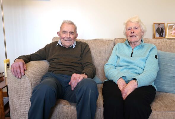 Tim and Sally Blake sitting on their sofa