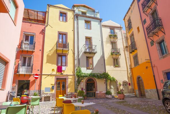 View of the colorful town of Oliena on a hill in Sardinia in sunlight in spring