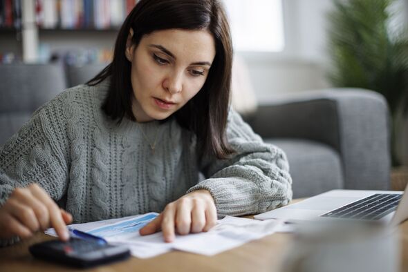 Woman reviewing bills and documents at home