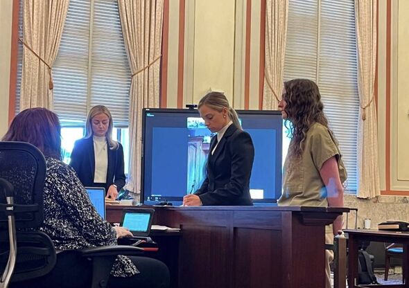 Hannah Johnson, right, stands before Judge Melba Marsh