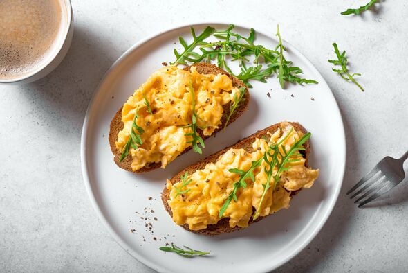 Scrambled Eggs sandwiches and cup of coffee for breakfast